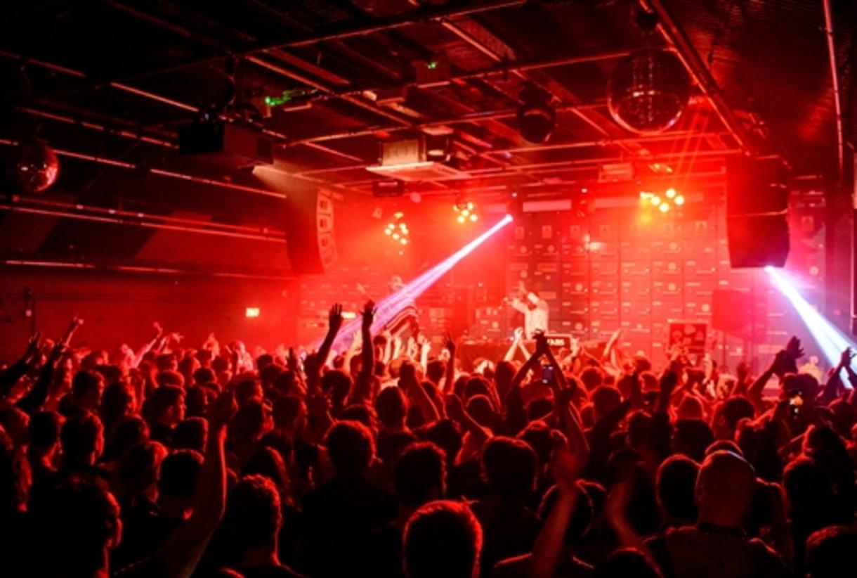 Vibrant disco club event with dynamic lighting and engaged audience in Gorilla. - Banner
