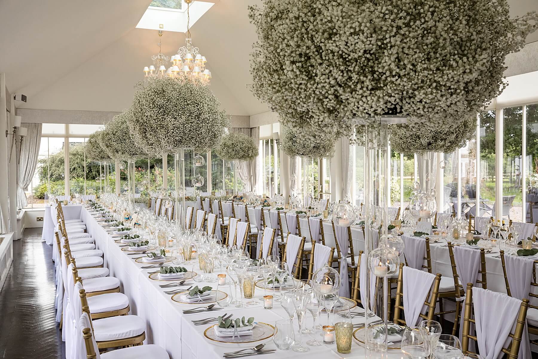 Monochrome baby’s breath centerpieces at The Orangery, Carlowrie Castle for luxury wedding gala.
