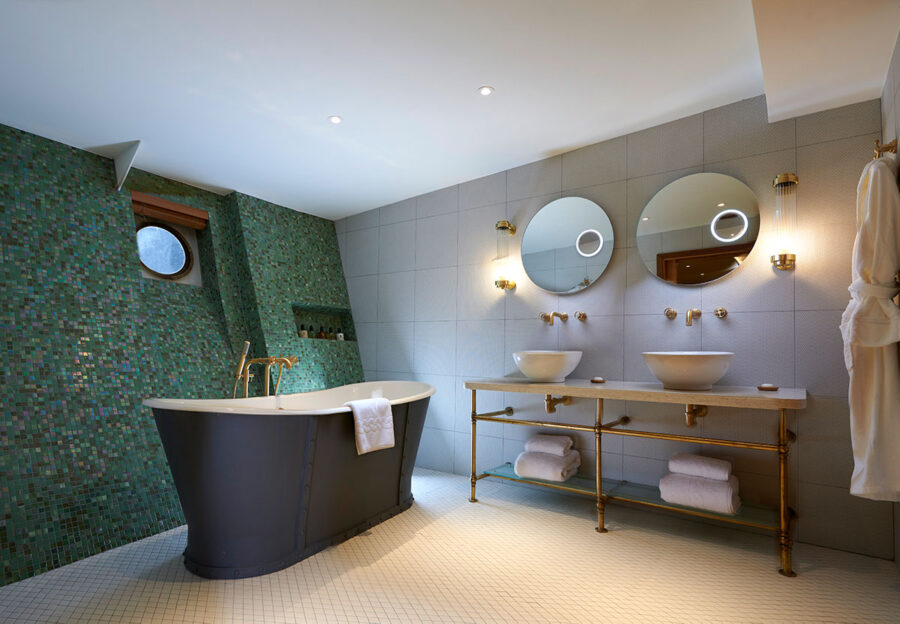 Luxury Fingal Hotel bathroom with emerald mosaic wall for executive site inspections and events.