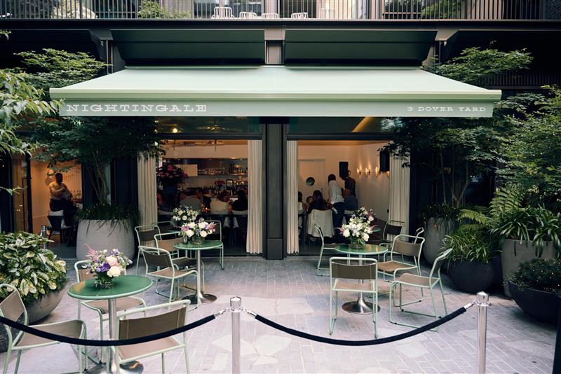 Outdoor dining at Nightingale, 1 Hotel Mayfair – lush greenery, ideal for networking events.