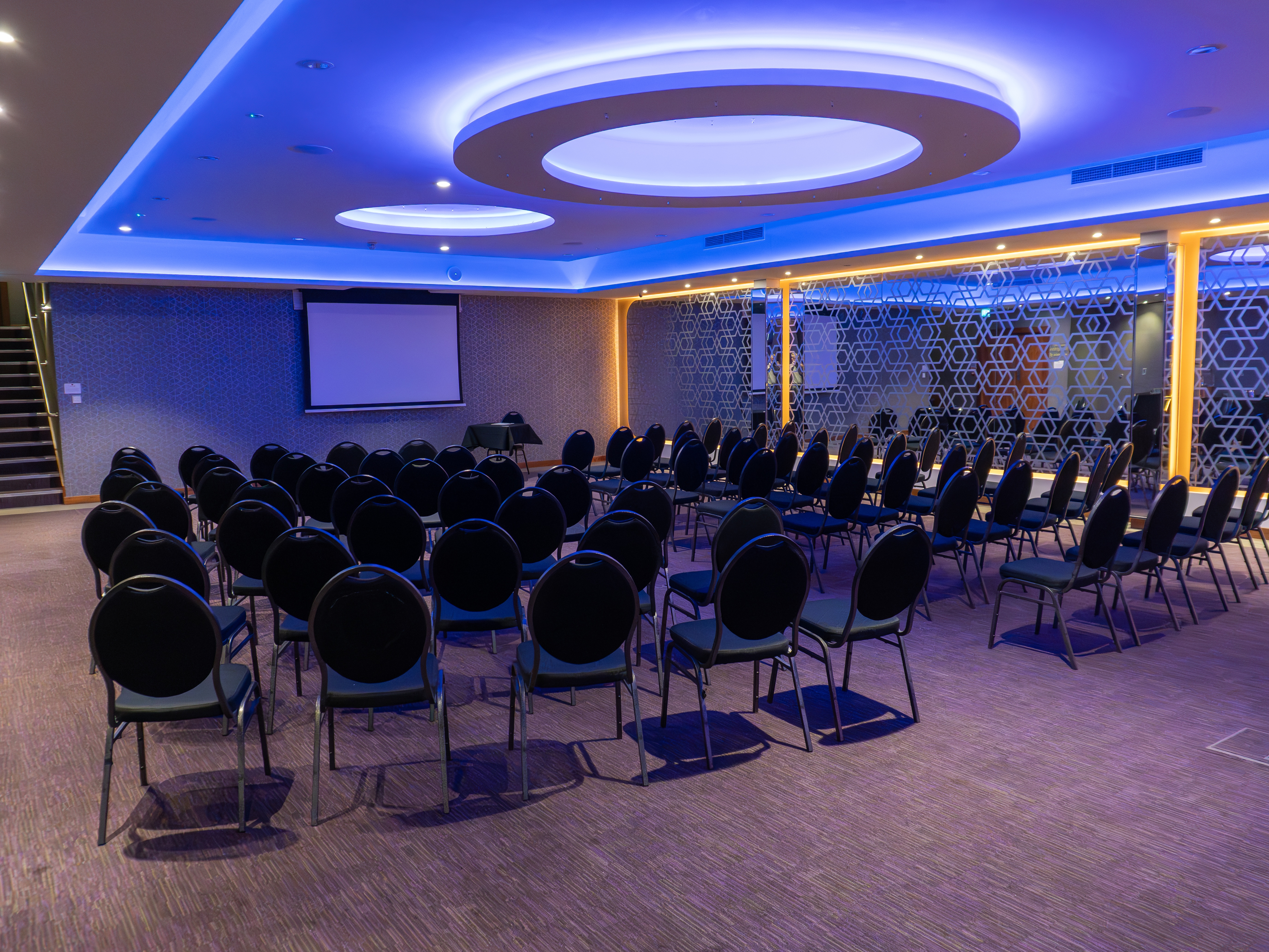 Modern meeting space at The York, featuring rows of chairs for corporate events.