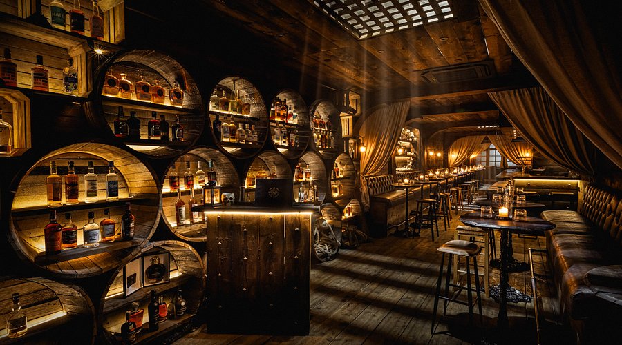 Rhum Tavern cocktail bar with barrel shelving, ideal for VIP networking and experiential events.