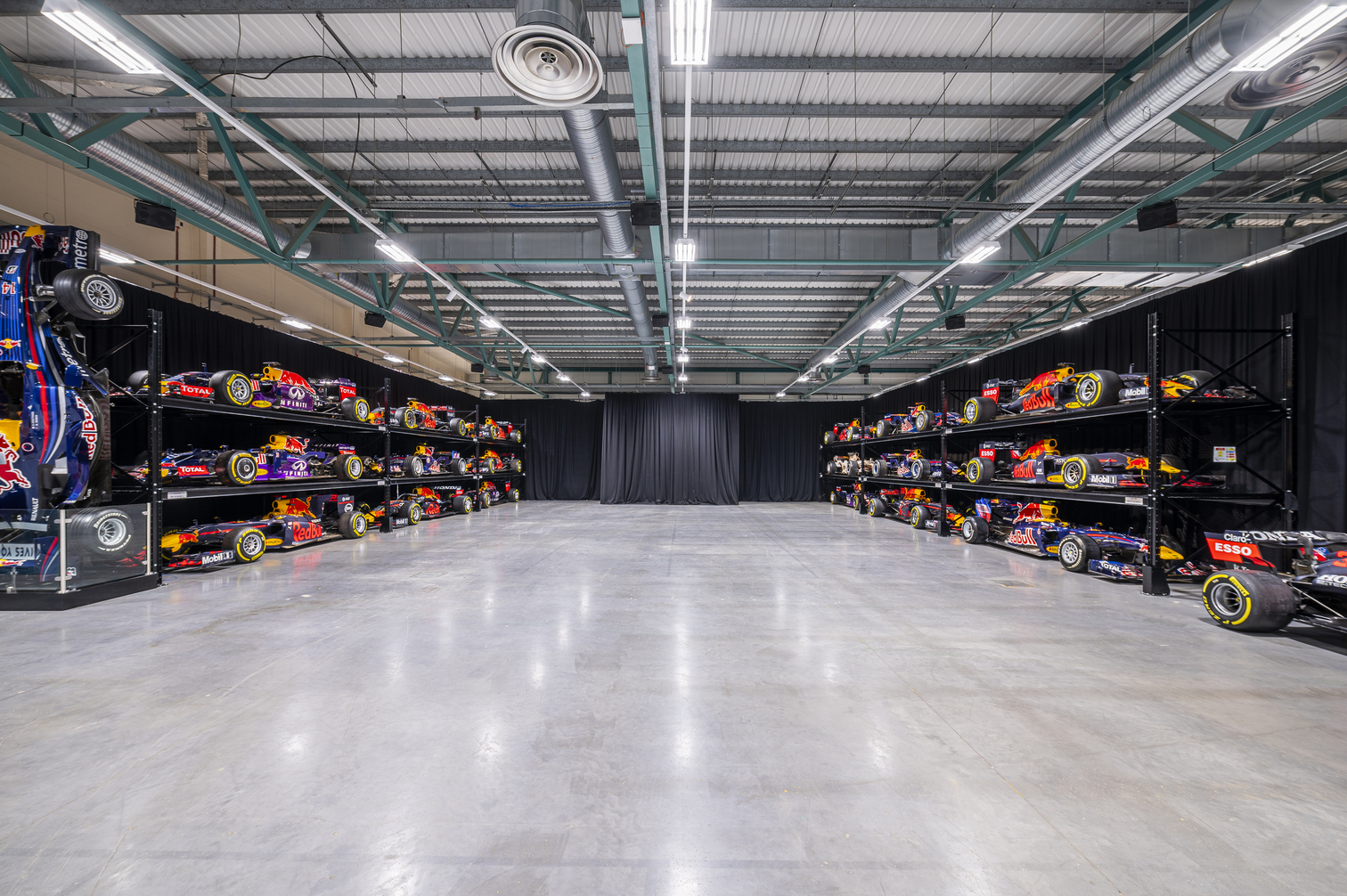 MK-7 Warehouse venue with sleek racing car displays for corporate events and product launches.