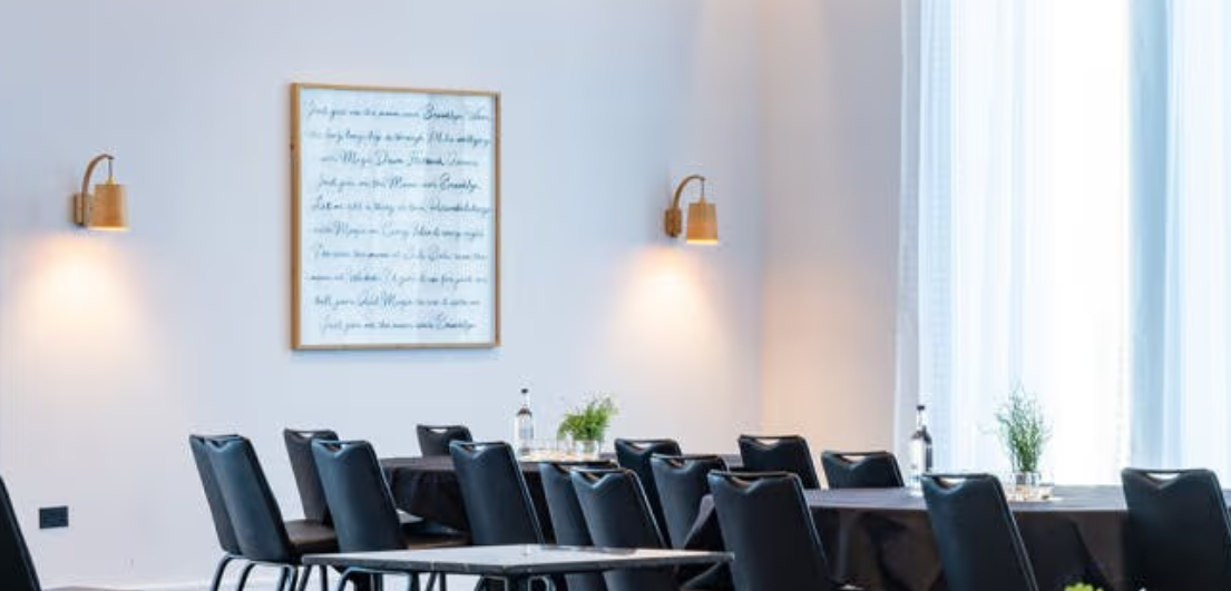 Modern meeting room in voco Manchester City Centre for corporate events and workshops.