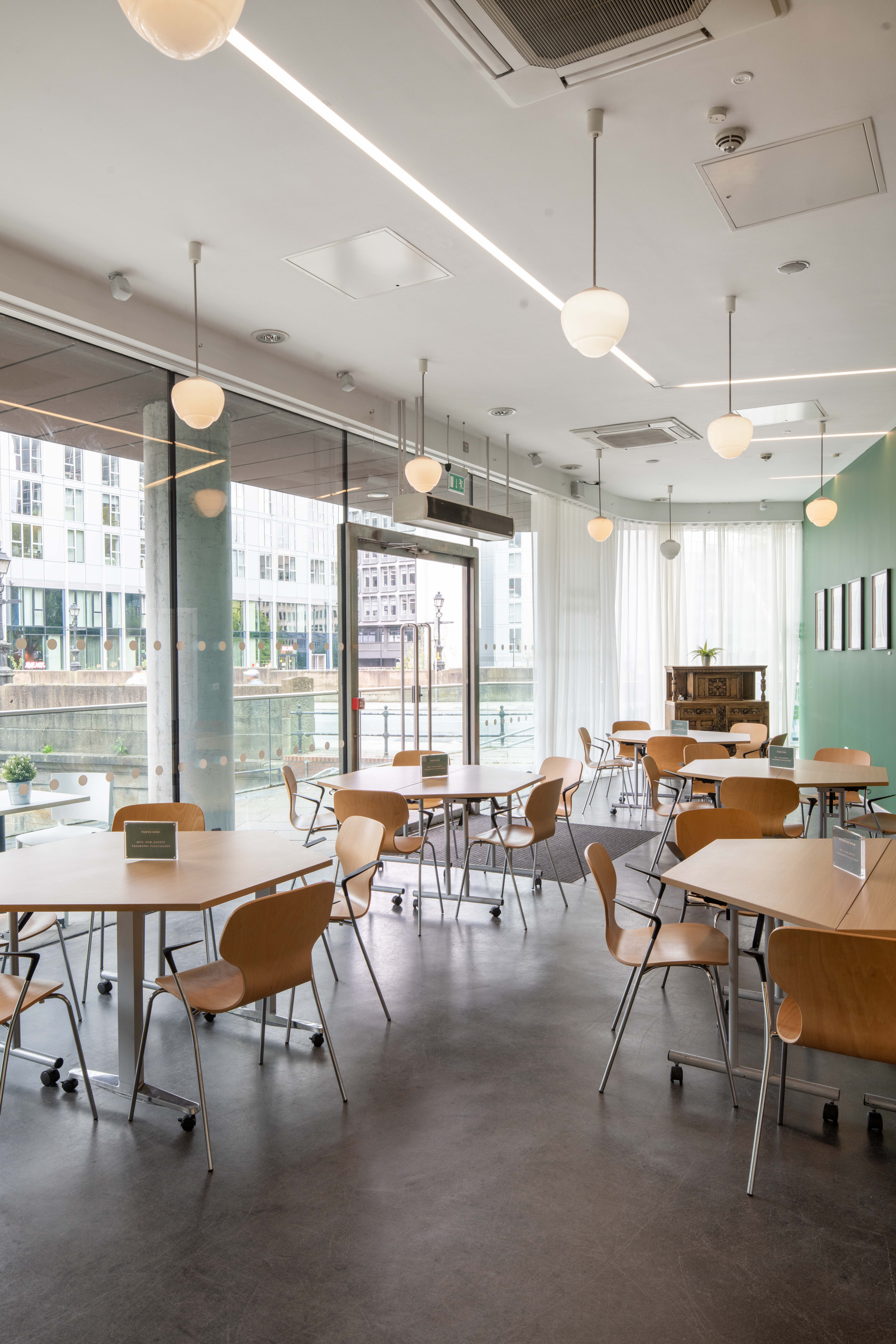 Riverside Room event space with natural light, ideal for meetings and presentations.