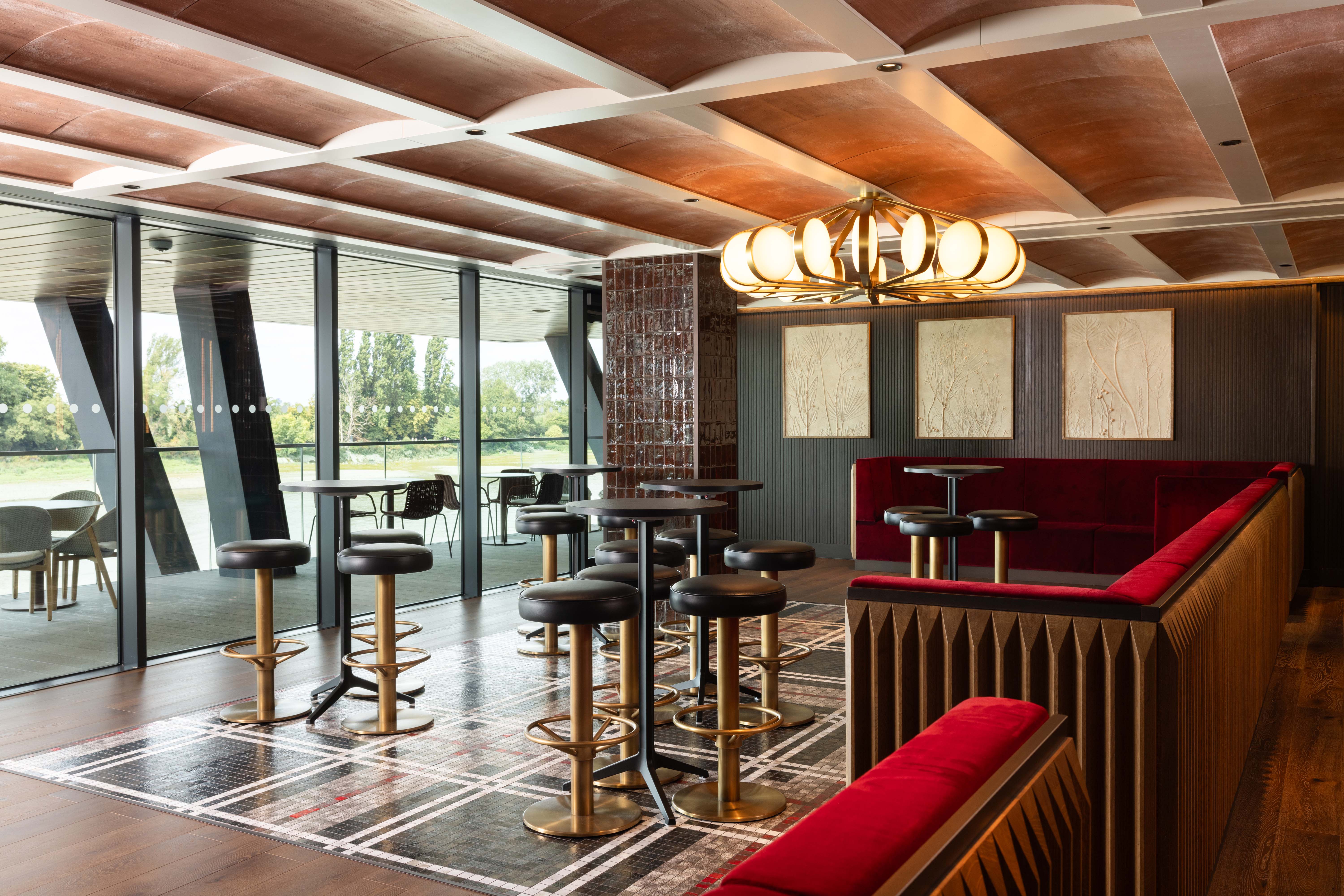 Upscale Fulham Pier breakout space with floor-to-ceiling windows for cocktail hours and networking.