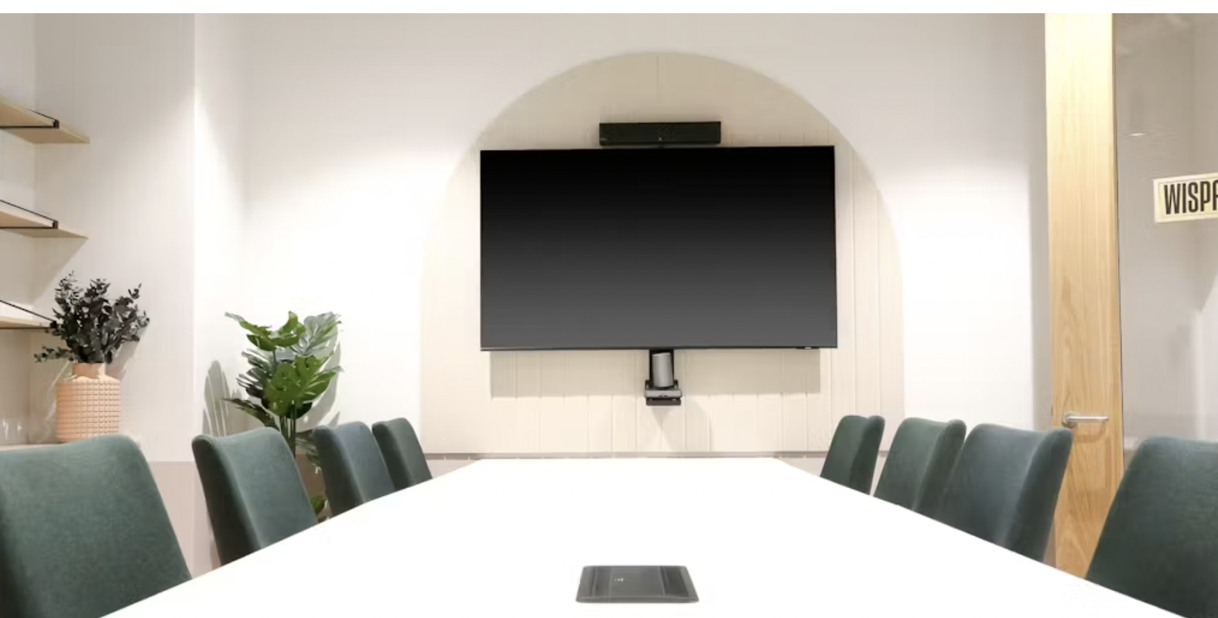 Modern meeting room in Runway East Birmingham with sleek table and green chairs. - Banner