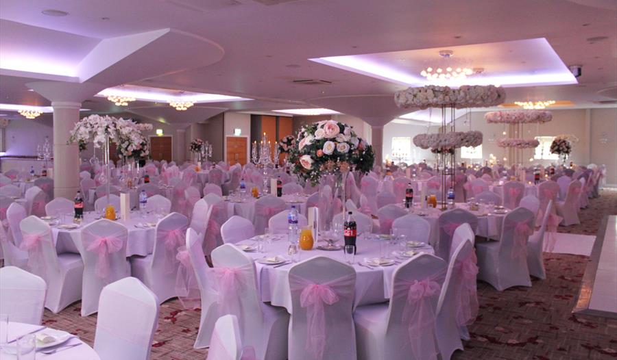 Main Suite at Grand Royale: elegant round tables with floral centerpieces for weddings.