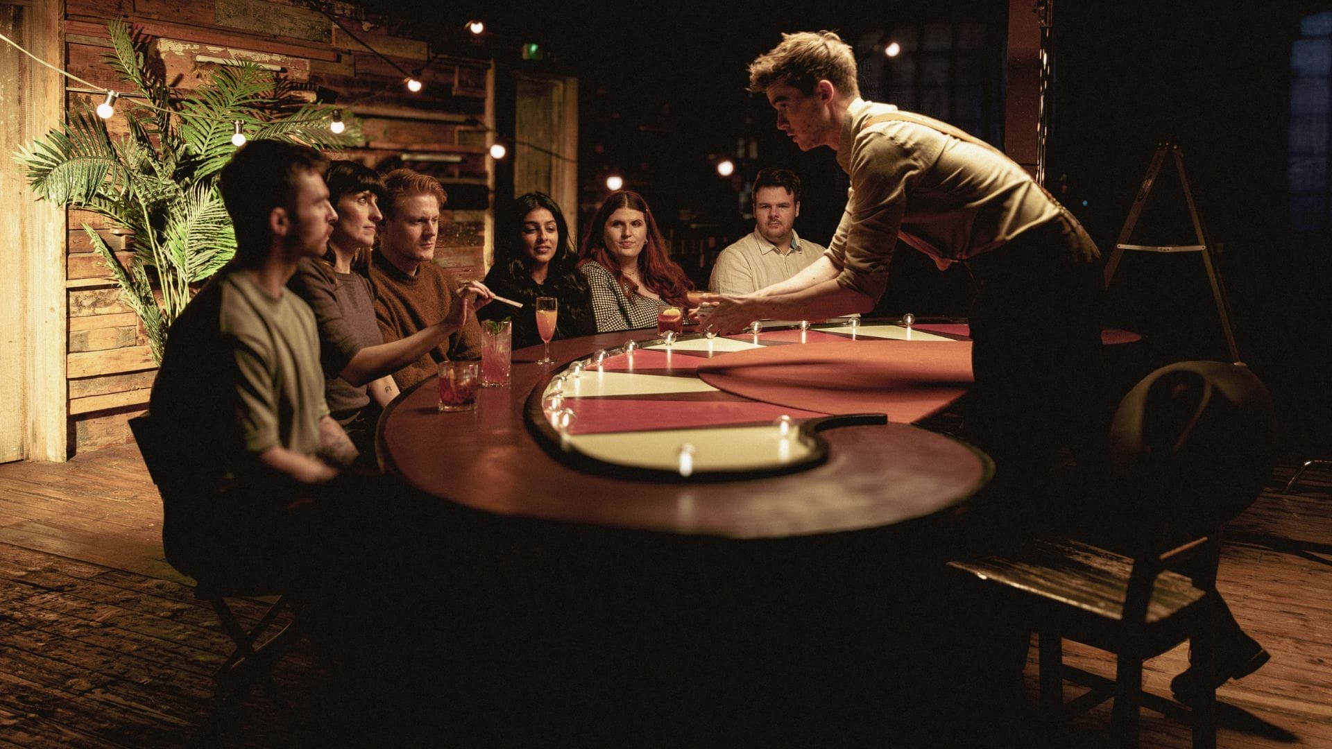 Team-building event at The Magicians Table with ambient lighting and rustic setting.