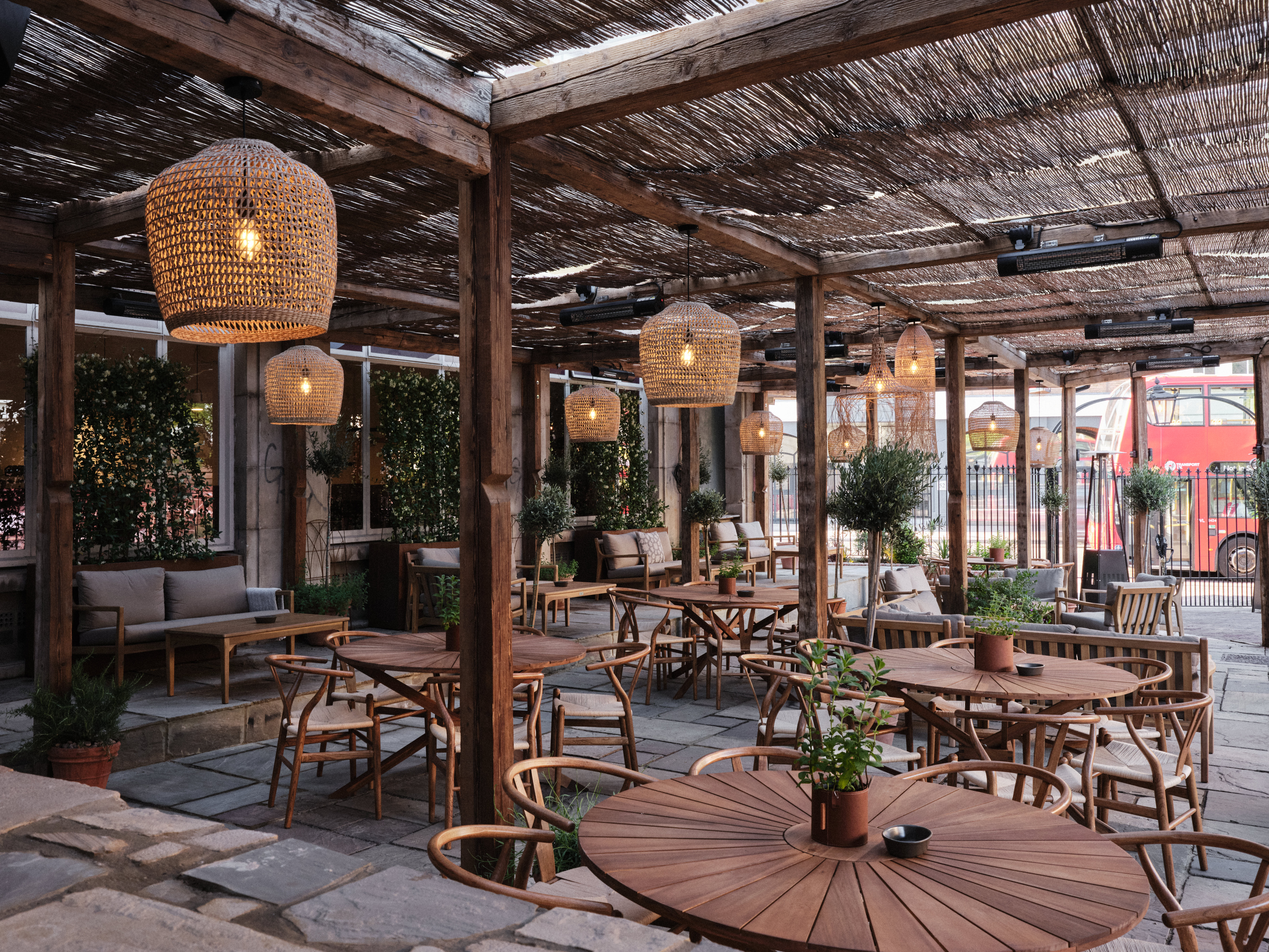 Pyro Terrace & Garden Bar with rustic wooden furniture, ideal for networking events.