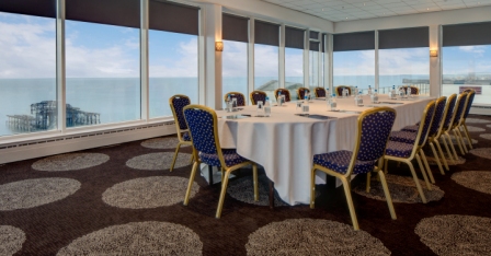 Chartwell room at DoubleTree Brighton with round table and natural light for meetings.