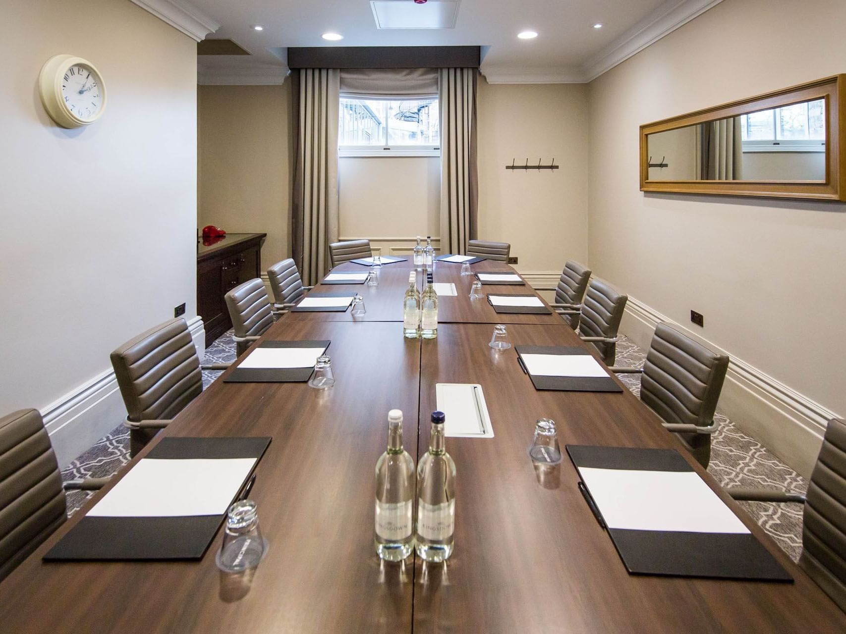 Boardroom meeting space with sleek furniture and natural light at The Milner York.