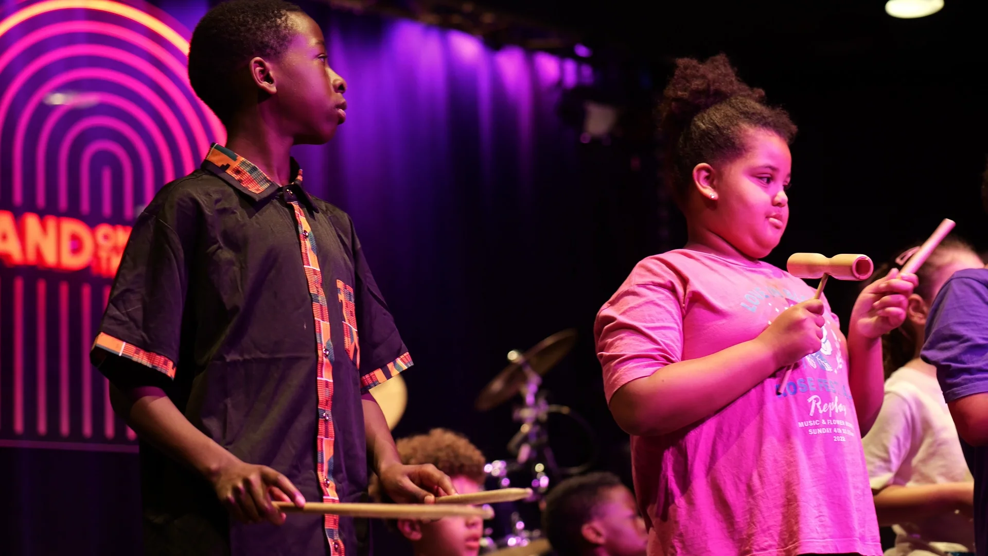 Youth musical performance at Band on the Wall with high-contrast stage lighting.