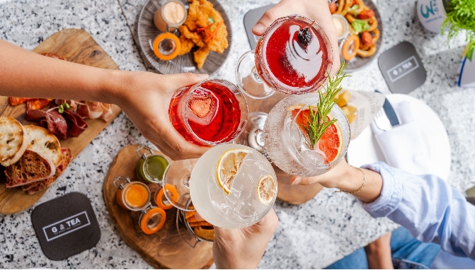 Vibrant toast at G&Tea Lounge, cocktails and appetizers for networking and celebrations.