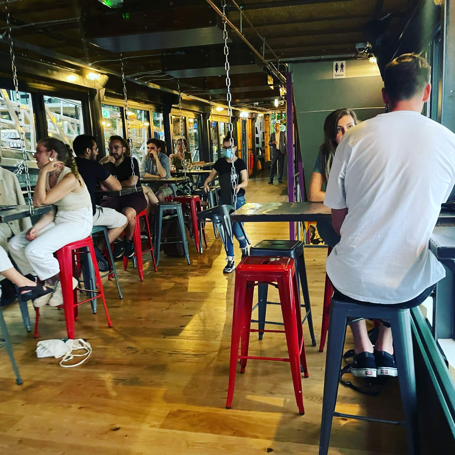 Indoor Middle Deck at Battersea Barge: vibrant venue, industrial decor for networking events. - Banner
