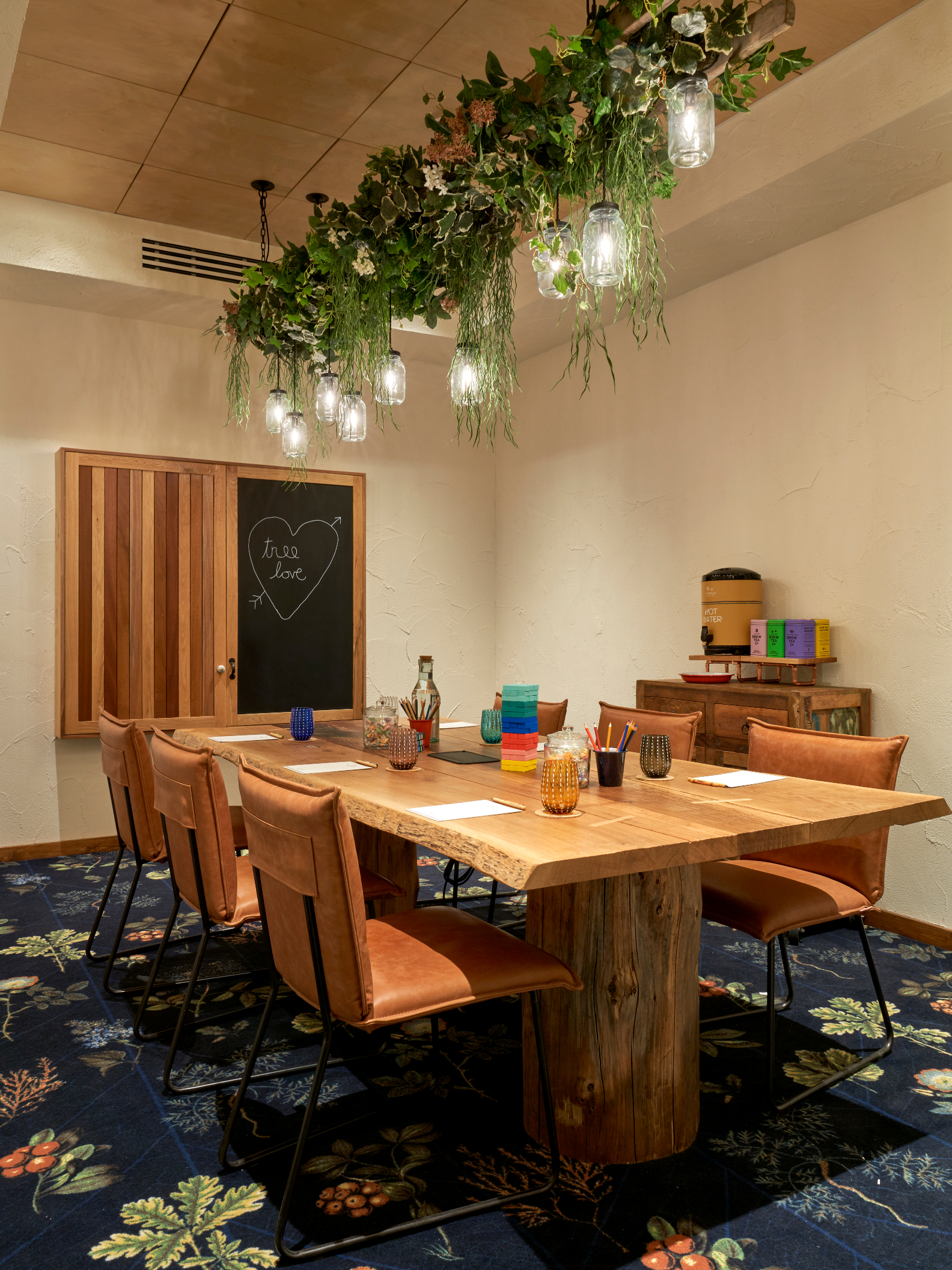 Acorn meeting space at Treehouse Hotel Manchester, featuring a warm wooden table for workshops.
