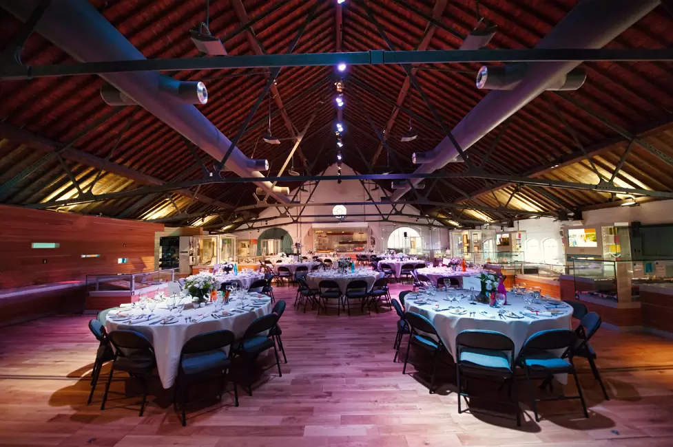 Elegant event space with round tables in Warehouse Gallery, ideal for corporate gatherings.