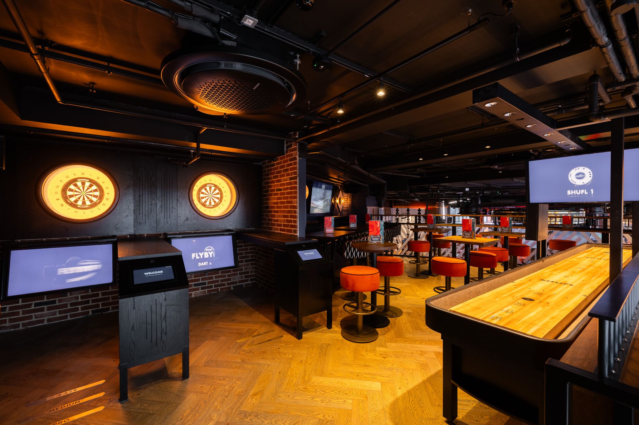 Modern event space Mezzanine at BOX Piccadilly with interactive dartboards for networking events.