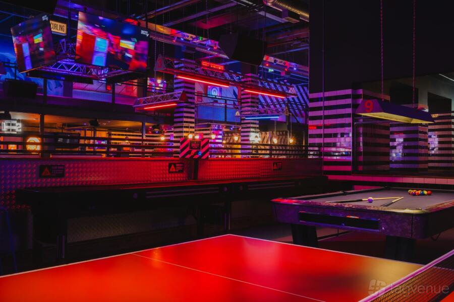 Flocc Room at Lace Market Hotel: vibrant event space with colorful lighting for corporate mixers.