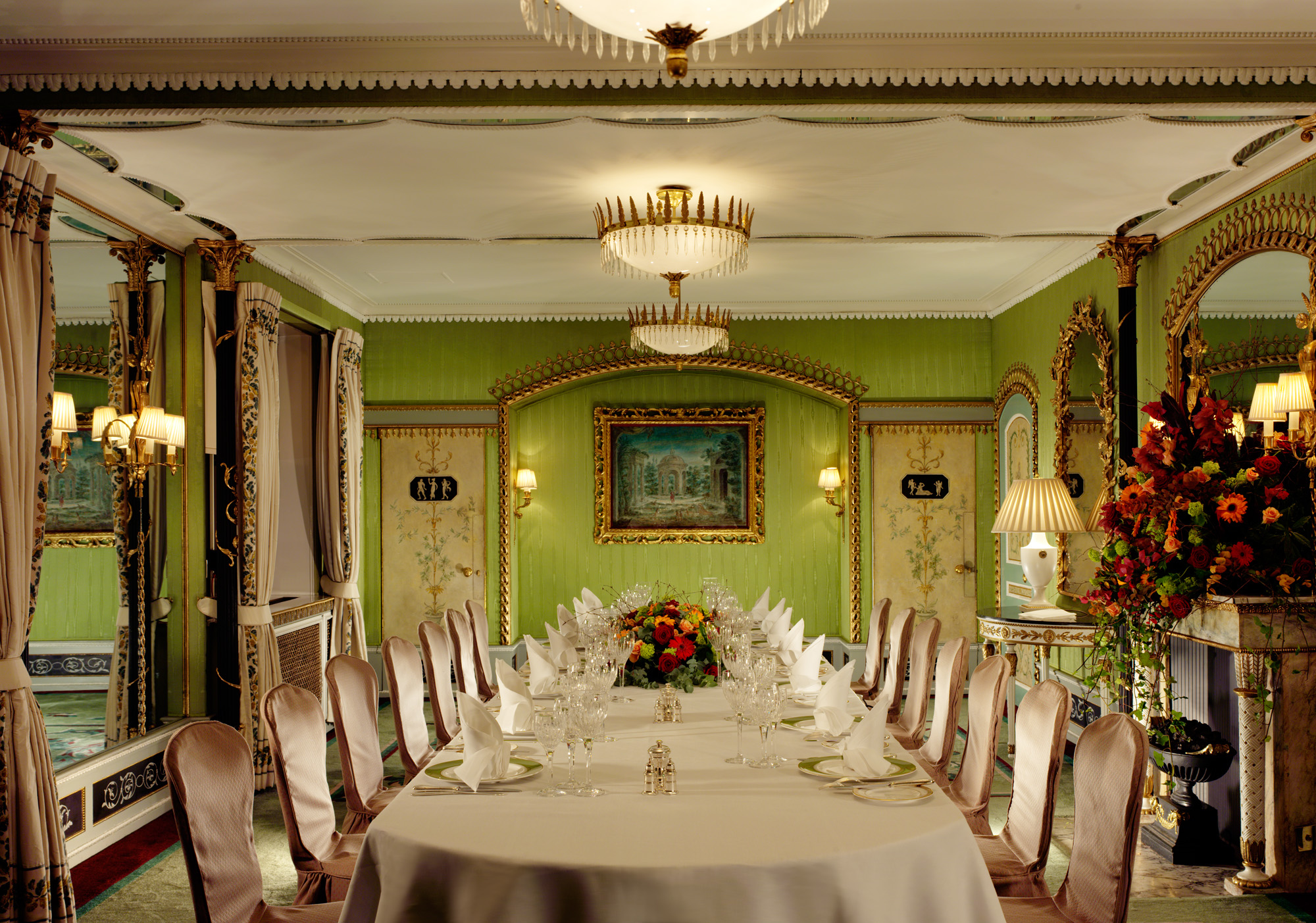 Elegant meeting room in The Dorchester with green walls, ideal for conferences and events.