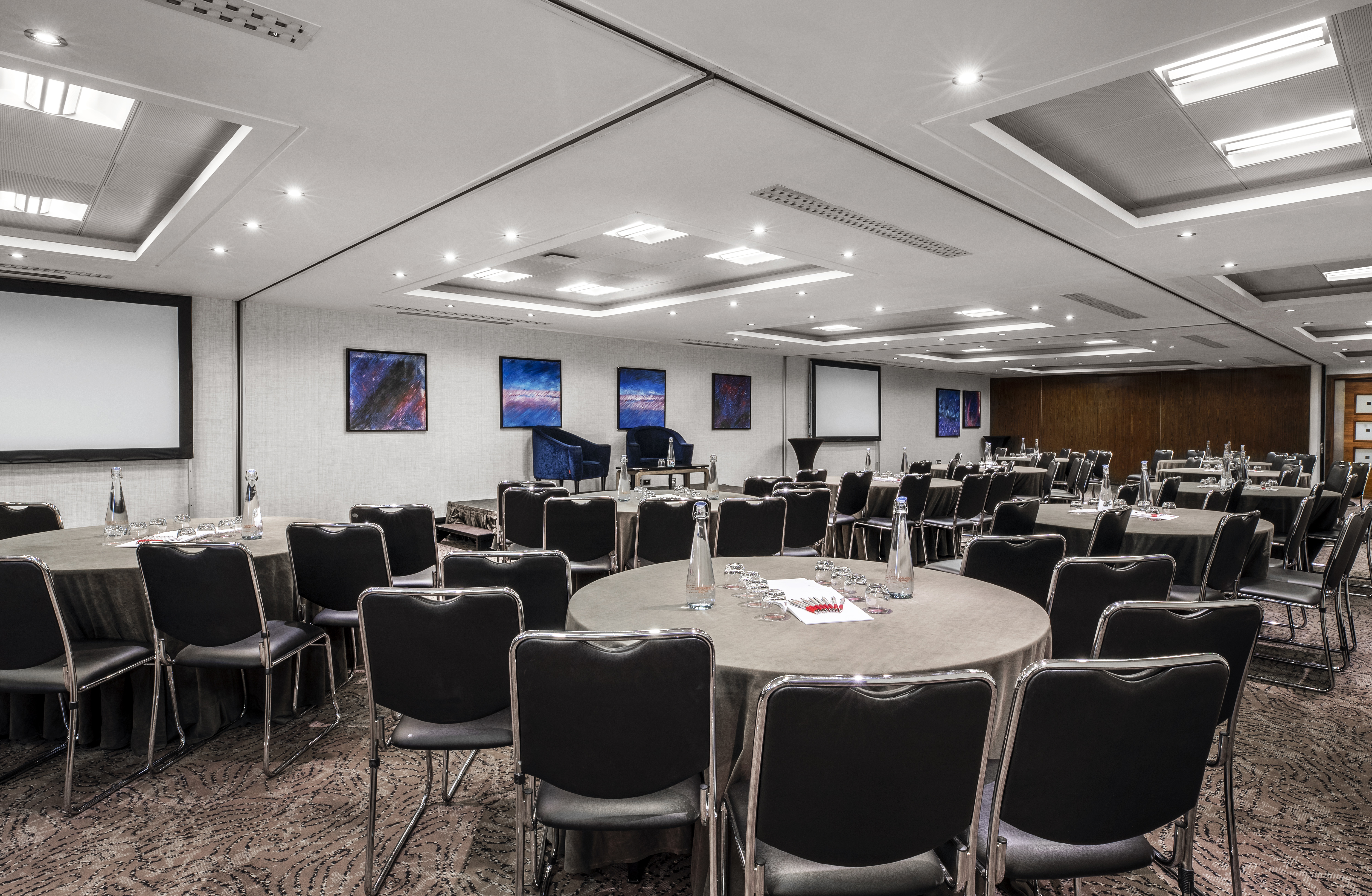 Milton Suite conference room at Leonardo Royal Hotel, London - modern event space with round tables.