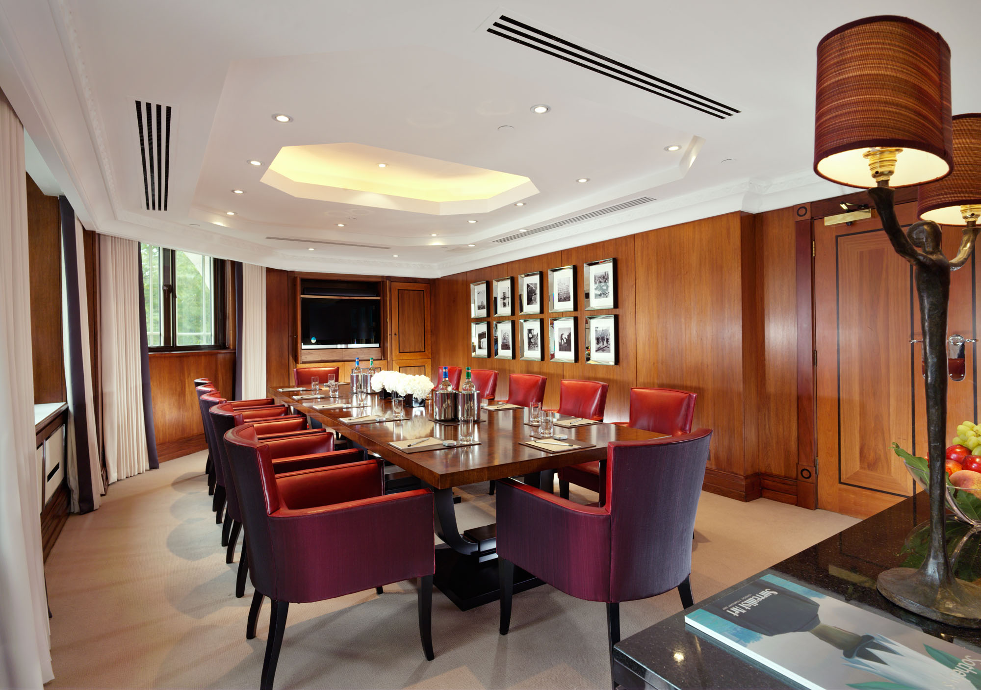 Sophisticated meeting room at The Dorchester with elegant wooden paneling, ideal for conferences.
