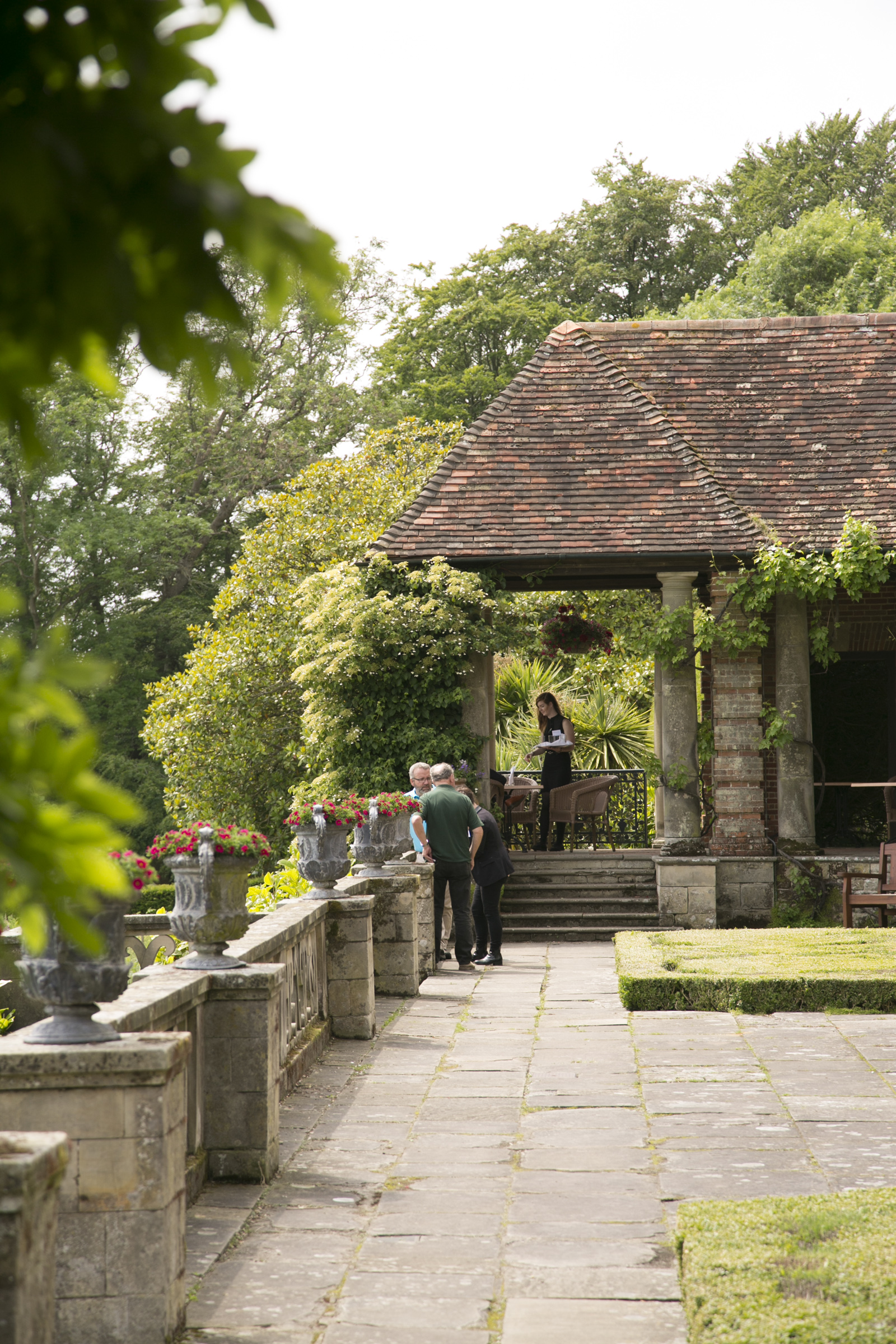 Outdoor wedding venue at Port Lympne Hotel with lush greenery and elegant architecture.