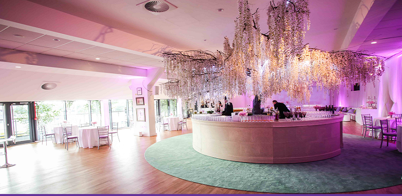 Elegant bar with floral arrangements at The Tulip Club, StoneX Stadium for upscale events.