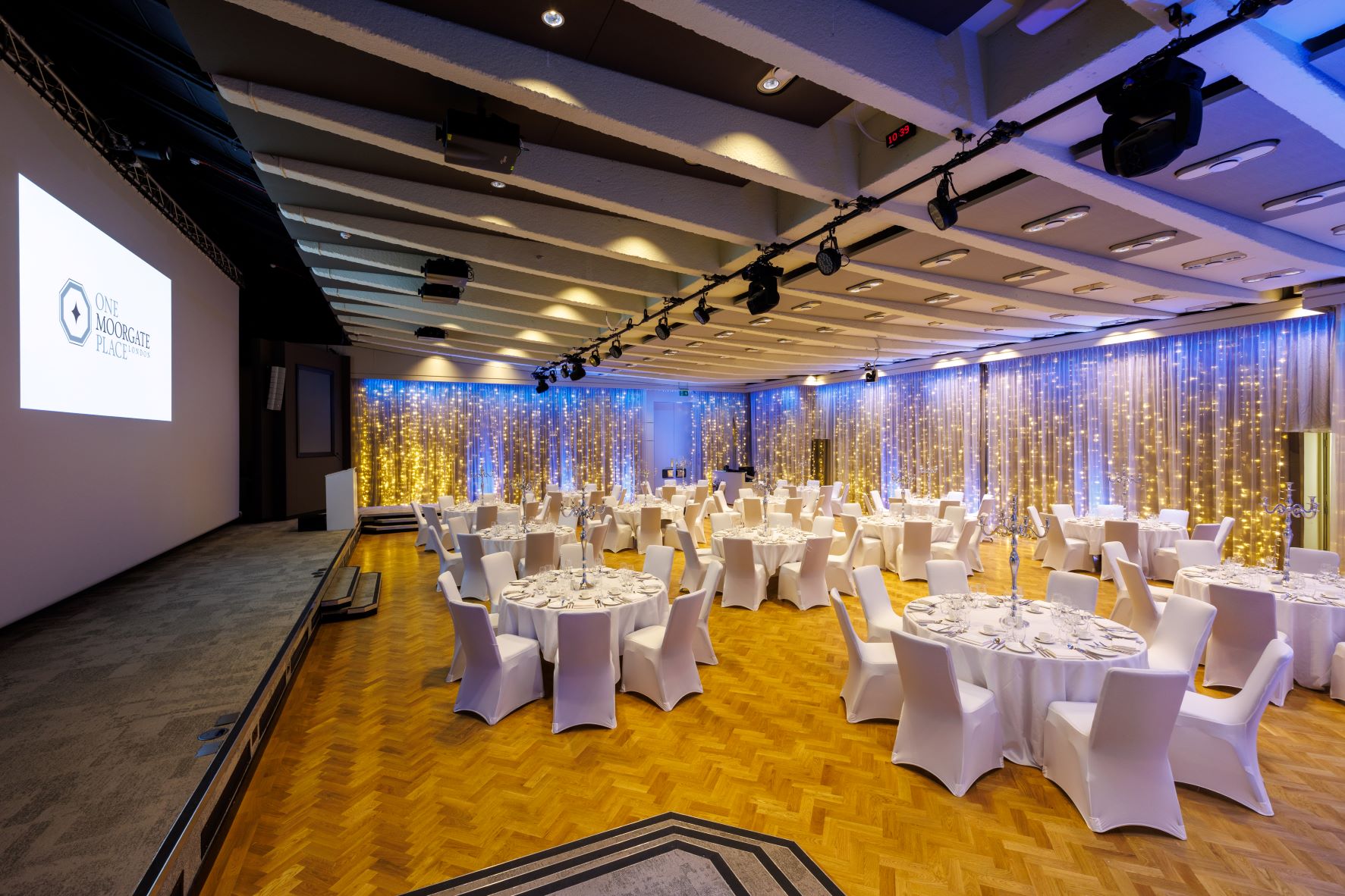 Great Hall at One Moorgate Place, elegant event space with round tables, ideal for celebrations.