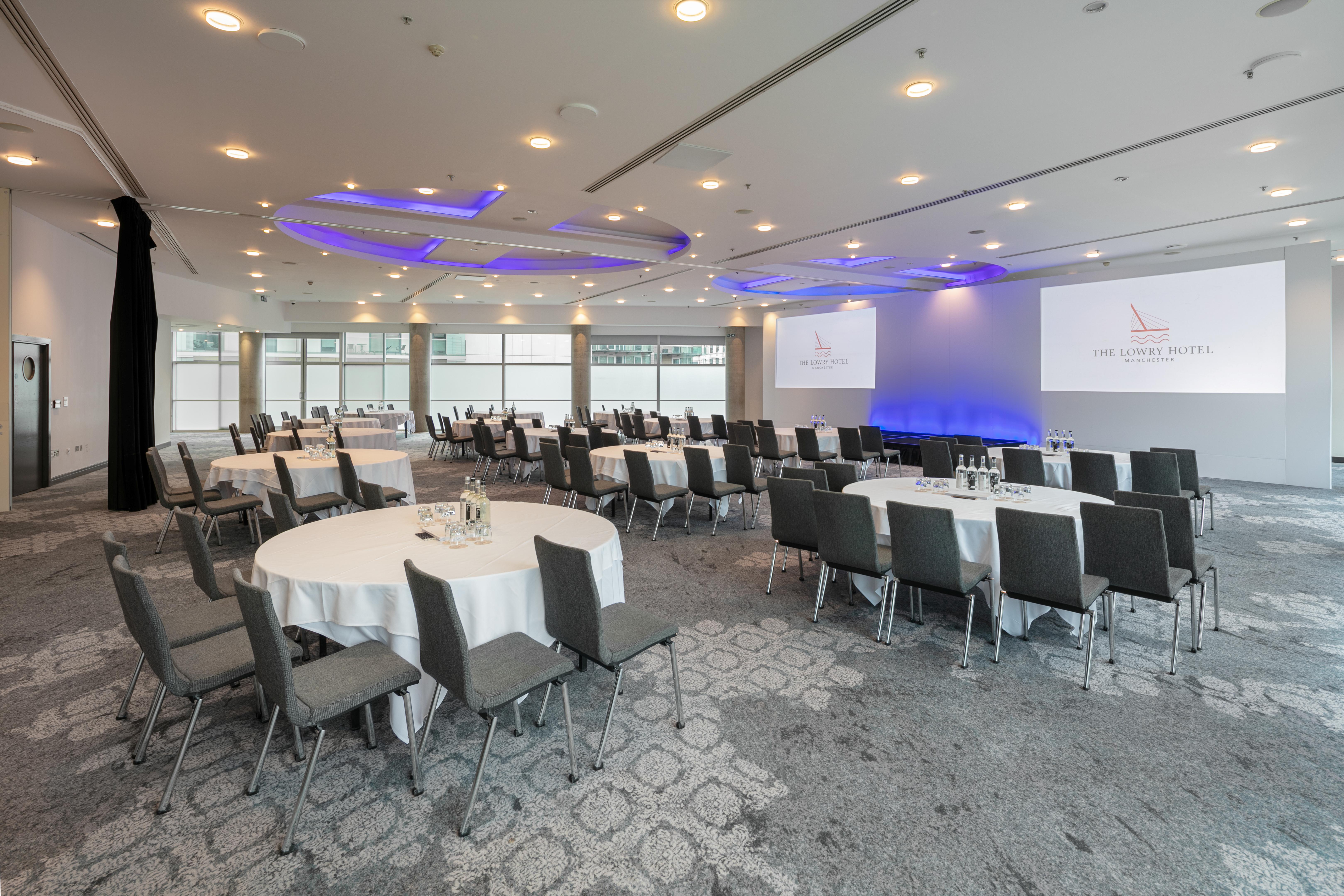 Grand Ballroom at The Lowry Hotel with round tables for corporate events and conferences.