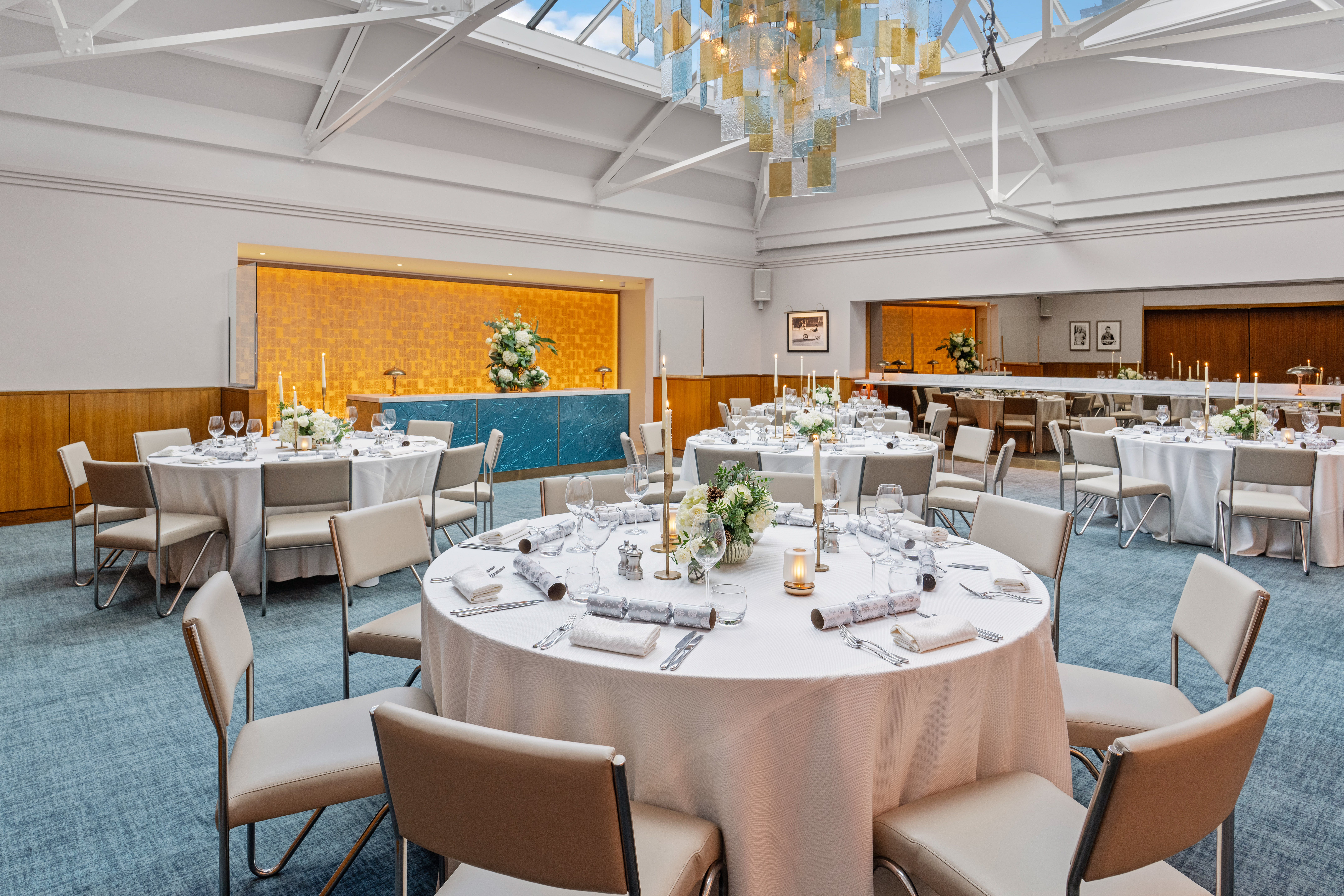 Elegant event space in Bluebird Chelsea with round tables and natural light.