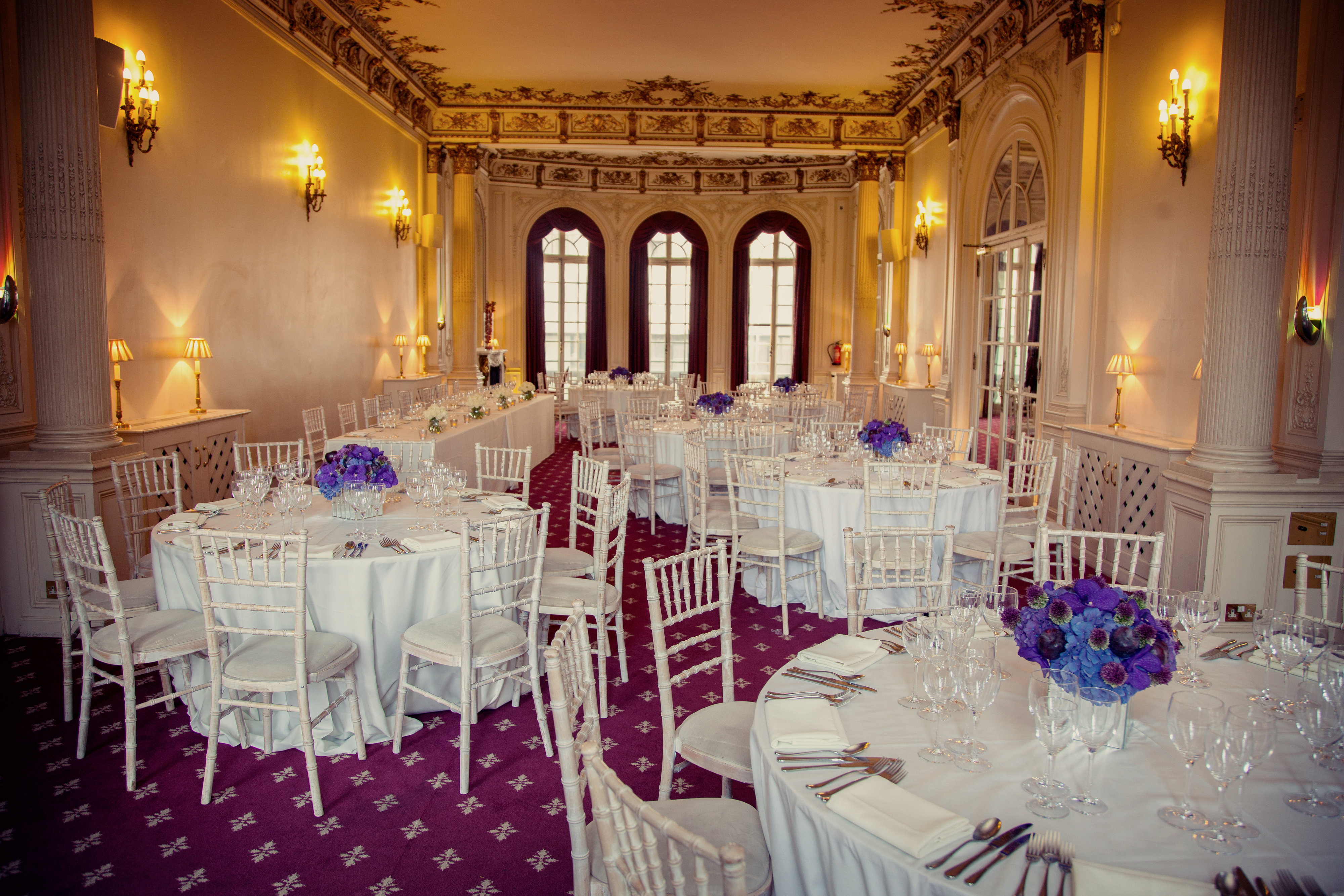 Elegant banquet room with floral centerpieces, perfect for weddings and corporate events.