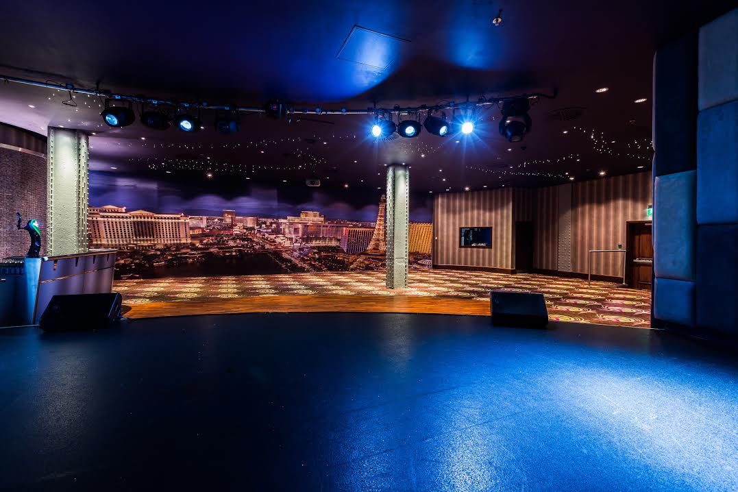 Private Events Suite in Manchester 235 with stage and city skyline, ideal for corporate events.